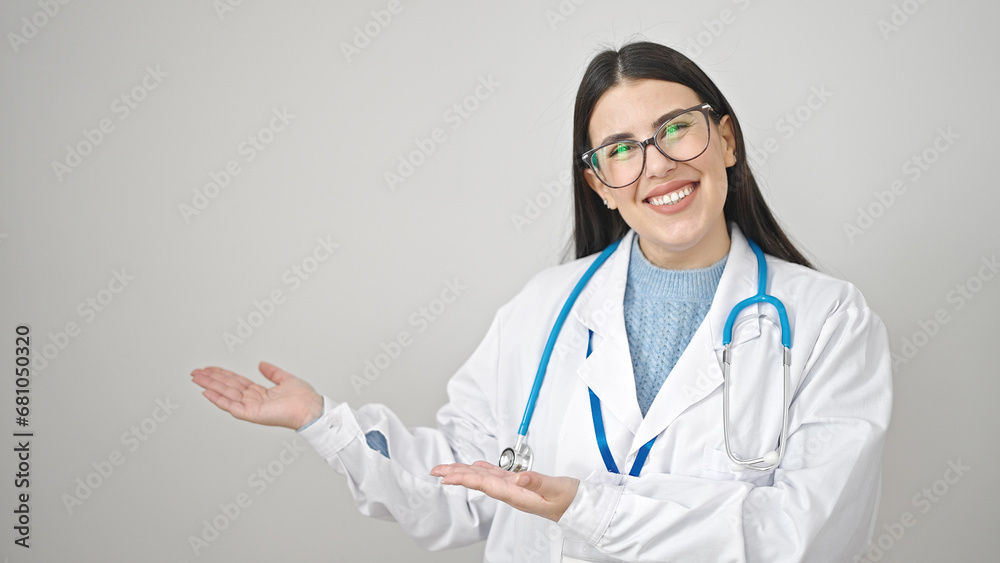 Young hispanic woman doctor smiling confident presenting over isolated white background Young hispanic woman doctor smiling confident presenting over isolated white background