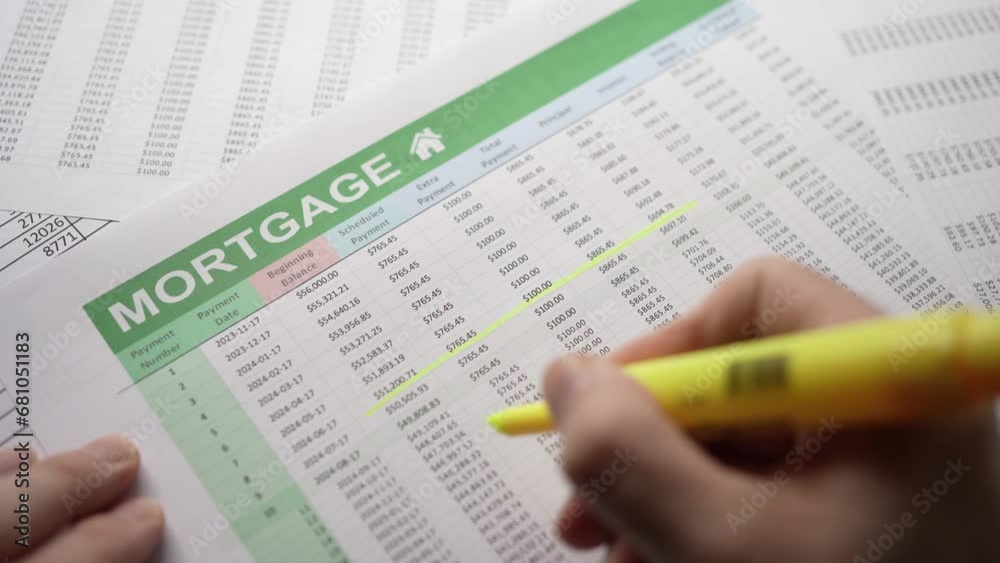 Accountant making calculation over a Mortgage Spreadsheet Accountant making calculation over a Mortgage Spreadsheet