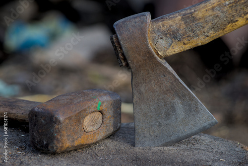 Sledgehammer and ax on wooden base