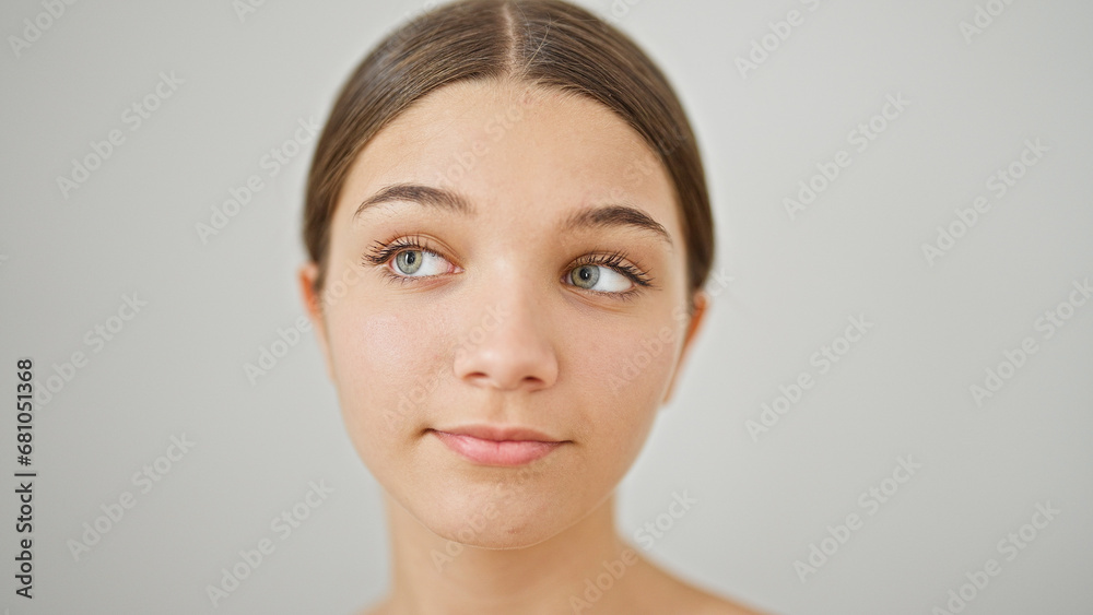 Young beautiful girl standing with relaxed expression looking to the side over isolated white background Young beautiful girl standing with relaxed expression looking to the side over isolated white background