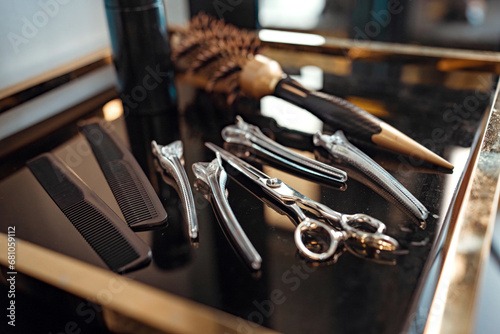 Closeup - Hairdressing scissors and barber accessories in hair salon, Professional tools for haircut in barber shop. Hairdressing concept photo