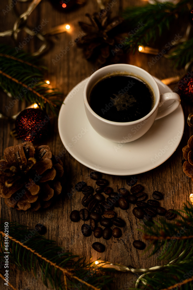 Obraz premium Coffee break on Christmas evening. A cup of espresso coffee on the table