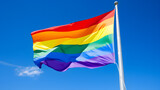 Pride Rainbow Flag Waving Against a Clear Blue Sky
