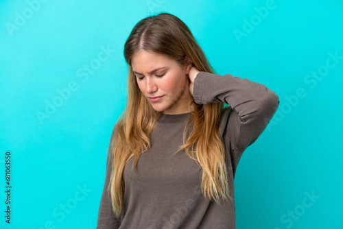 Young blonde woman isolated on blue background with neckache