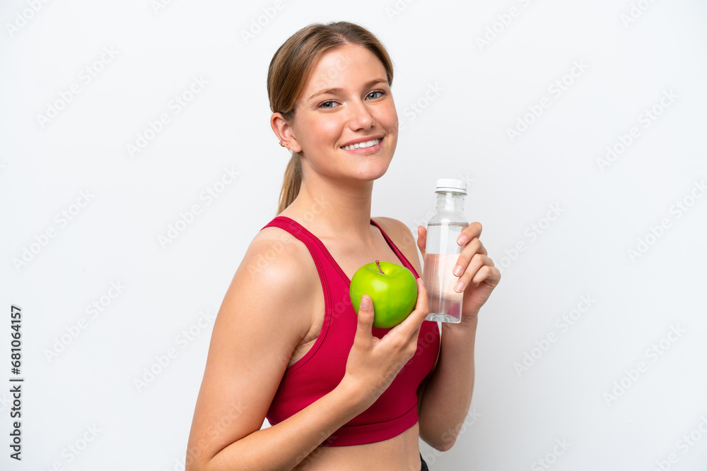 Young pretty blonde woman isolated on white background with an apple and with a bottle of water Young pretty blonde woman isolated on white background with an apple and with a bottle of water