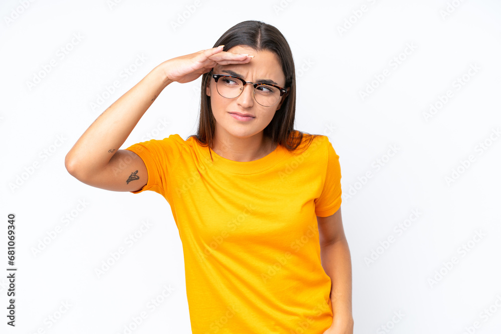 Young caucasian woman isolated on white background looking far away with hand to look something Young caucasian woman isolated on white background looking far away with hand to look something