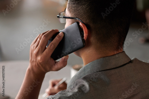 Businessman calling colleague to discuss development strategy photo