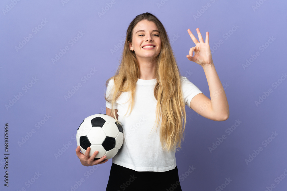 Young blonde football player woman isolated on purple background showing ok sign with fingers Young blonde football player woman isolated on purple background showing ok sign with fingers