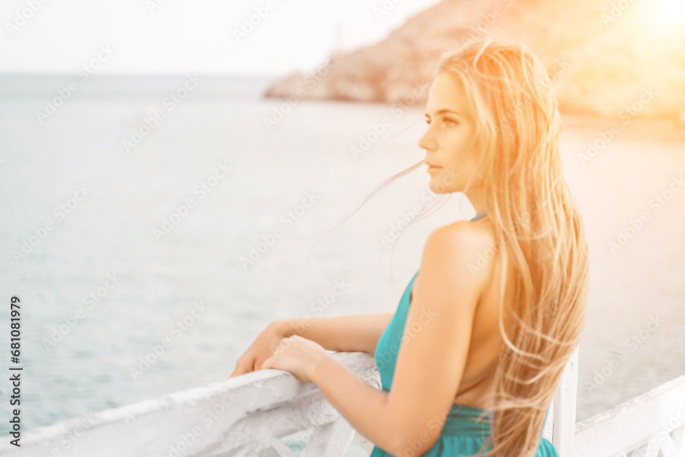 Woman sea trevel green dress. Side view a happy woman with long hair in a long mint dress posing on a beach with calm sea bokeh lights on sunny day. Girl on the nature on blue sky background. Woman sea trevel green dress. Side view a happy woman with long hair in a long mint dress posing on a beach with calm sea bokeh lights on sunny day. Girl on the nature on blue sky background.
