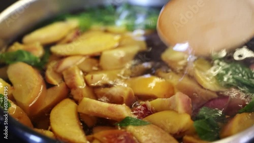 Pot with freshly brewed compote. Delicious fruit compote. Compote of peaches