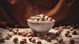 Whole hazelnuts in a bowl and scattered on the table