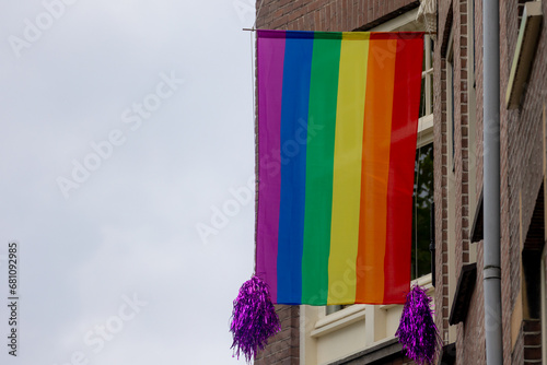 Celebration of pride month in Amsterdam, Rainbow flags hanging outside building along street, Symbol of Gay, Lesbian, Baisexaul and Transgender, LGBT community in Holland, Social movement, Netherlands