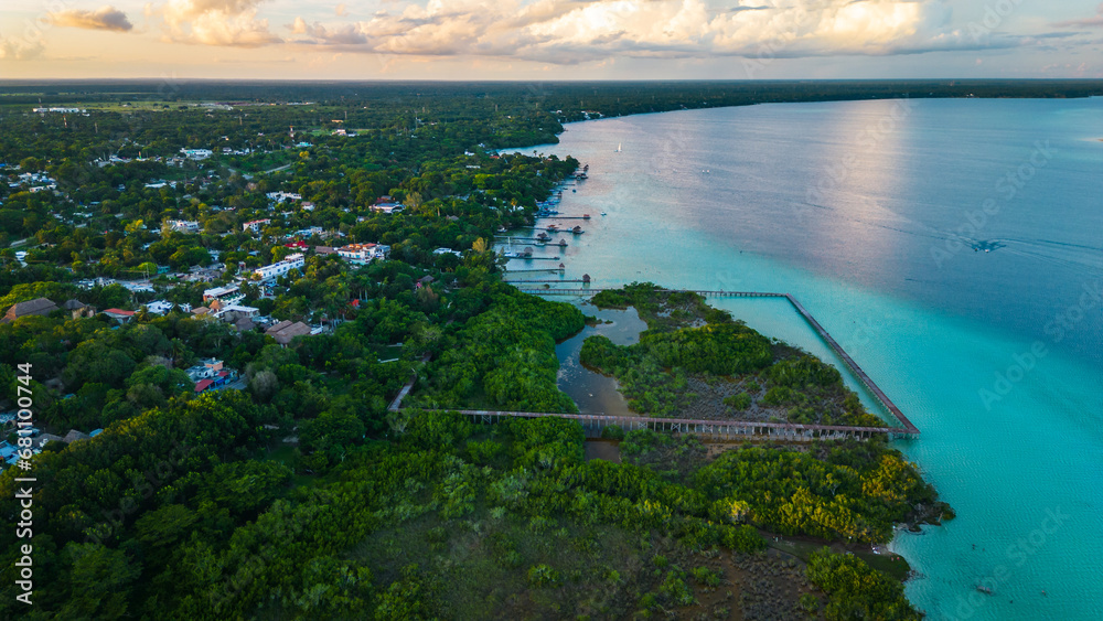 Aerial of seven colours lake lagoon in Bacalar Mexico drone fly above beach resort town in Quintana Roo 