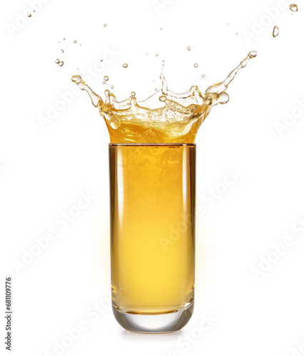Crown-shaped splash of apple juice overflowing out of a tall glass isolated on white background..