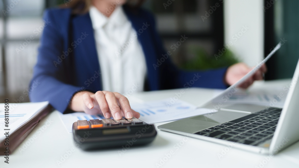 .Financial inspector calculating a numbers in office room.. .Financial inspector calculating a numbers in office room..