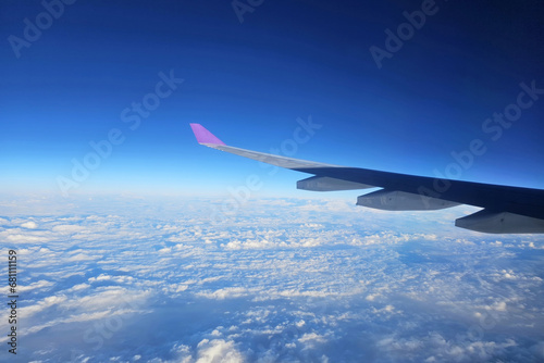 Close up Airplane Wing with Beautiful Blue Sky Background.