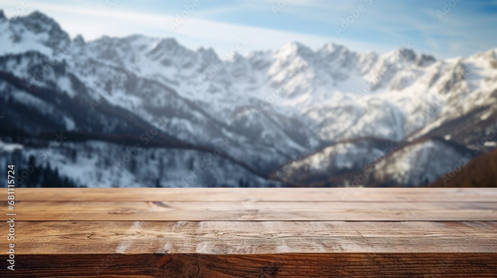Close up wooden table with snowy mountains in the background.