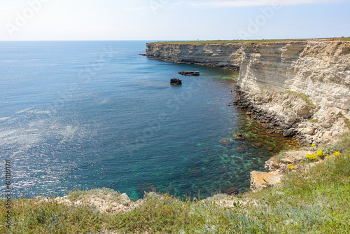 Cape Tarkhankut on the Crimean peninsula. The rocky coast of the Dzhangul Reserve in the Crimea. The Black Sea. Turquoise sea water. Rocks and grottoes of Cape Tarkhankut. photo