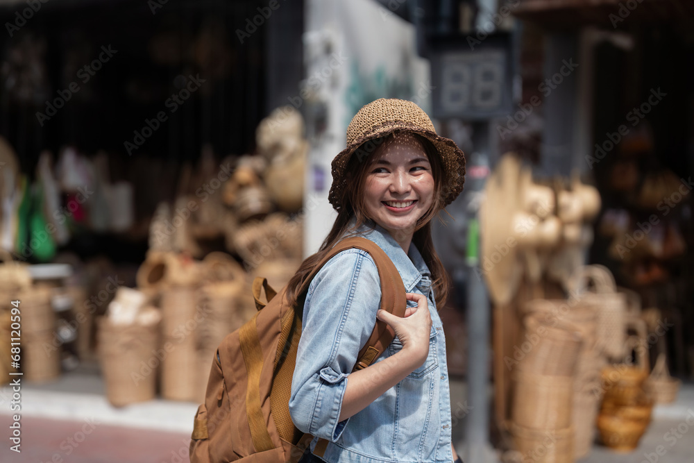 Young beautiful woman traveling at the local market during vacation. Tourist women travel in Chiang mai enjoy shopping market during holidays, backpacker traveller