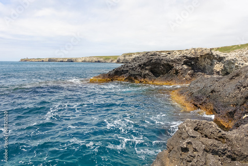 Cape Tarkhankut on the Crimean peninsula. The rocky coast of the Dzhangul Reserve in the Crimea. A sunny summer day. The Black Sea. Turquoise sea water. photo