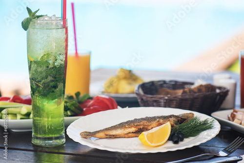 Fried grayling fish on a pa...