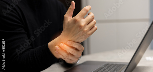 close up manager man massage on hand to relief pain from hard working for treatment about carpal tunnel syndrome and chronic illness health care concept photo