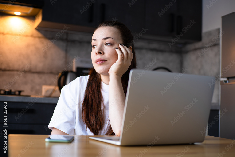 Work on the kitchen office. Remote work from home office. Young woman making videocall. Freelancer workplace at kitchen table. Distance education Work on the kitchen office. Remote work from home office. Young woman making videocall. Freelancer workplace at kitchen table. Distance education
