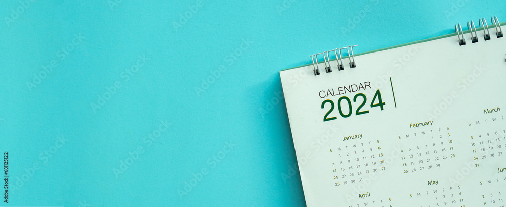close up top view on calendar 2024 on blue background with copy space for happy new year resolution and lifestyle concept - obrazy, fototapety, plakaty 