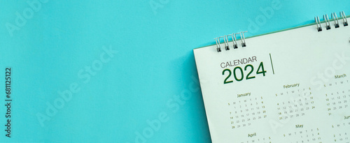 close up top view on calendar 2024 on blue background with copy space for happy new year resolution and lifestyle concept photo