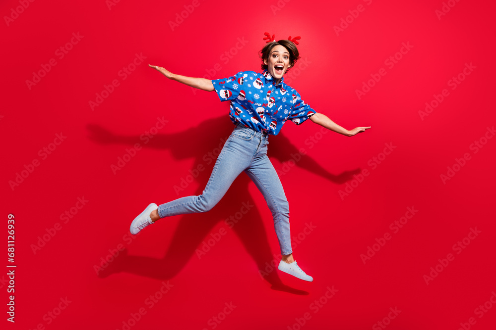 Full body photo of activity entertainment flying jumping charming young girl brown bob hair new year vibe isolated on red color background