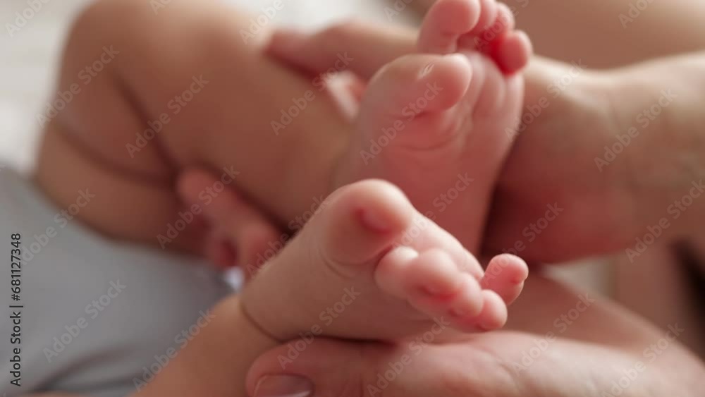 mother holding baby newborn feet. friendly family kid dream concept. mothers day concept. baby newborn in mother arms close-up lifestyle legs mother holding baby newborn feet. friendly family kid dream concept. mothers day concept. baby newborn in mother arms close-up lifestyle legs