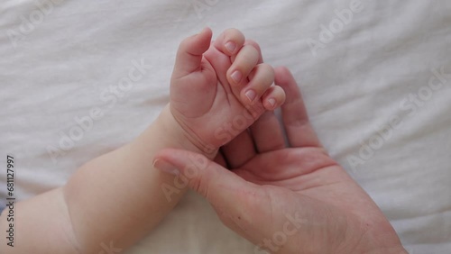 Mom holds baby hand. Happy family concept. Mother Day