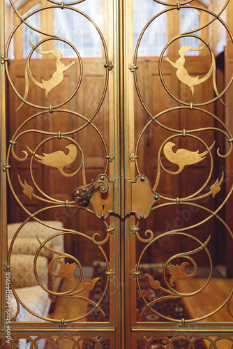 A Majestic Entrance: Ornate Gold Doors Adorned with Exquisite Bird Motifs