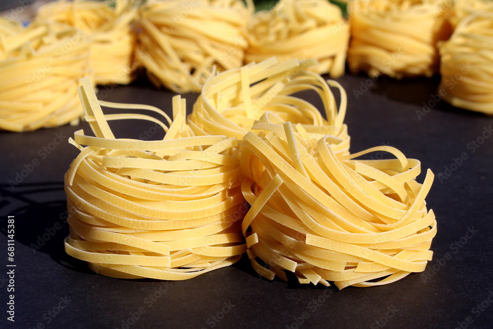 Round spaghetti lies on a black background. Round spaghetti lies on a black background.