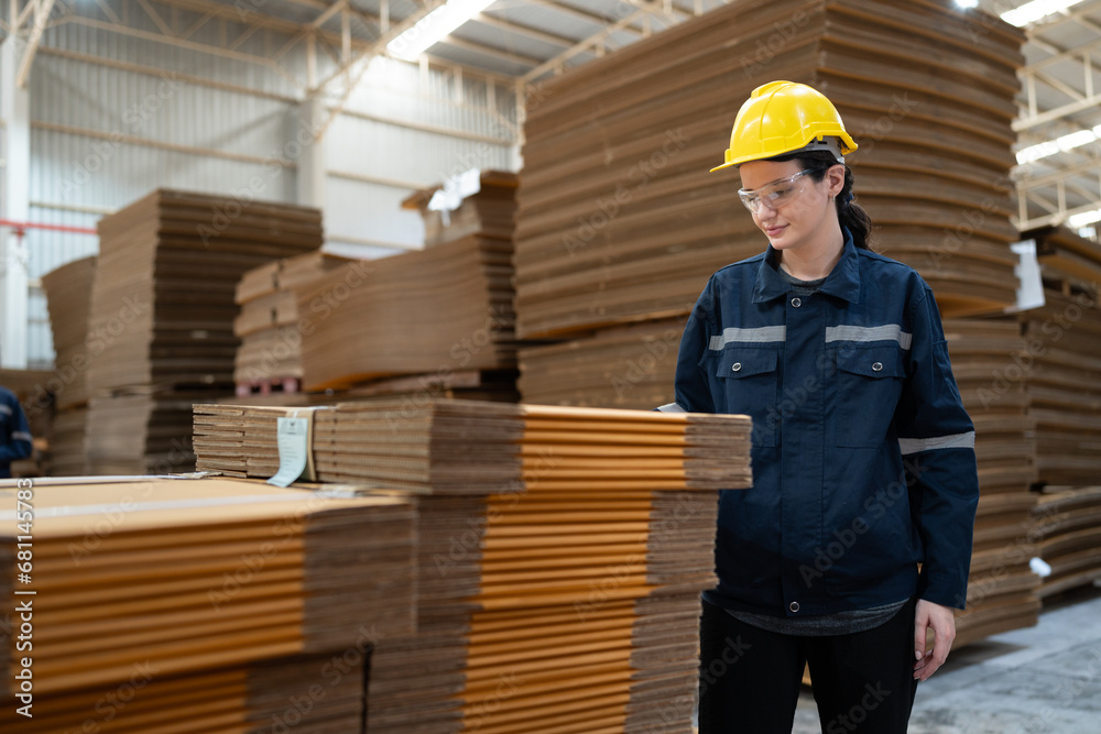 Caucasian businesswoman checking Kraft paper stock in warehouse Caucasian businesswoman checking Kraft paper stock in warehouse