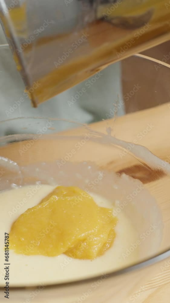 Vertical video. Pumpkin Cookie Recipe. Woman Adds Pumpkin Puree to the Bowl with the Dough. Vertical video. Pumpkin Cookie Recipe. Woman Adds Pumpkin Puree to the Bowl with the Dough.