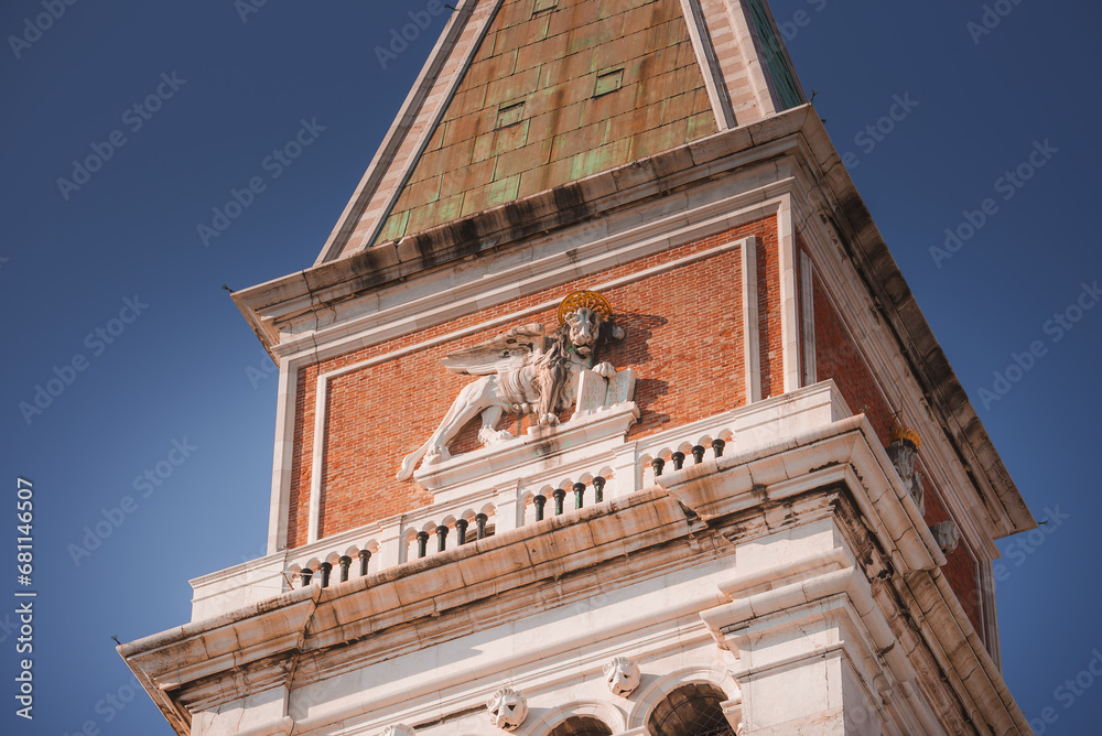 The winged lion sculpture-venetian symbol on St Marks Campanile facade- Campanile di San Marco-bell tower of St Marks Basilica in Venice, Italy, one of the most recognizable symbols of the ciy