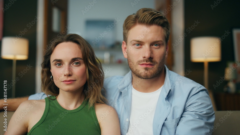 Fototapeta premium Portrait relaxed family sitting sofa at room. Calm couple watching television