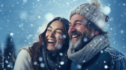 couple in christmas hats against snowy bokeh in winter 