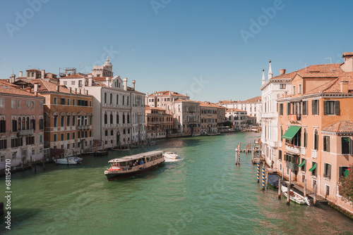 Scenic view of the Grand Canal in Venice, Italy, showcasing its beauty and tranquility. The specific angle, time of day, and types of boats are unspecified. © Aerial Film Studio
