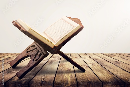 reading Quran holy book Quran on wooden seating