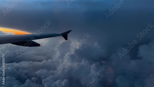 Aircraft Wing Flying in Sky Clouds Lightning Strike photo
