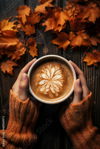 cup of hot delicious coffee with autumn leaves background. Top view, flat lay