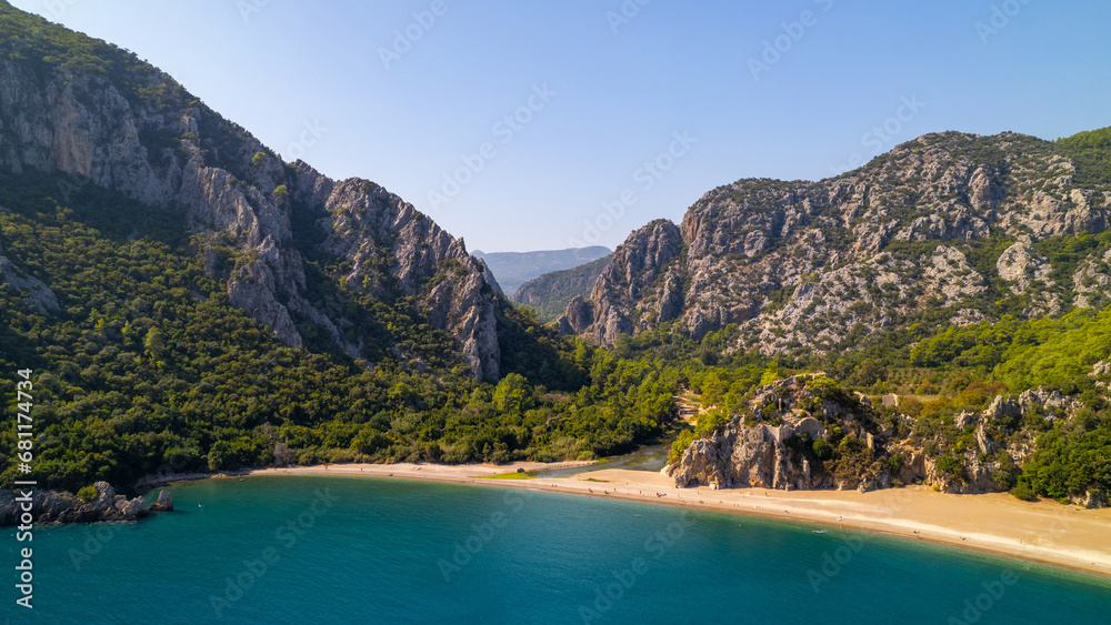 Obraz premium Captured the breathtaking beauty of Olimpos, Cirali Beach in Antalya, Turkey on a spectacular summer day in 2023, using a drone to explore the coastline and the majestic mountains in the background. 