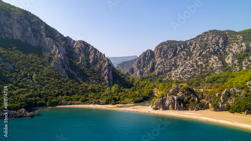 Fototapeta Naklejka Na Ścianę i Meble -  Captured the breathtaking beauty of  Olimpos, Cirali Beach in Antalya, Turkey on a spectacular summer day in 2023, using a drone to explore the coastline and the majestic mountains in the background. 