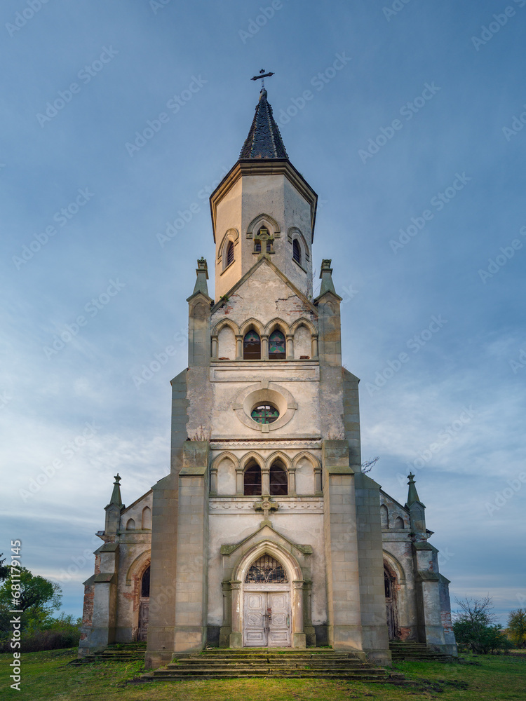 central view to facade of catholic abandoned cathedral in morning twilight