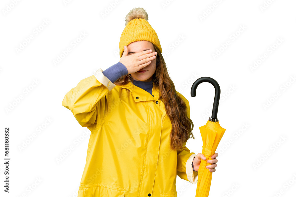 Teenager girl with rainproof coat and umbrella over isolated chroma key background covering eyes by hands. Do not want to see something Teenager girl with rainproof coat and umbrella over isolated chroma key background covering eyes by hands. Do not want to see something