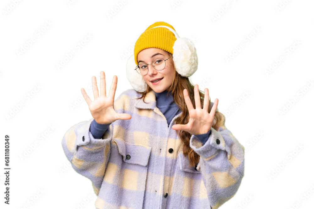 Teenager girl wearing winter muffs over isolated chroma key background counting ten with fingers