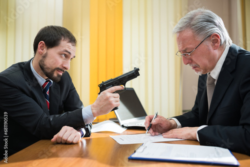 Criminal forcing a businessman to sign a contract photo