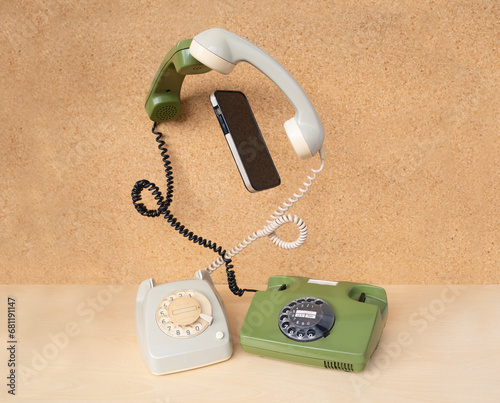Konstfotografi Two classic phones with levitating handsets and modern smartphone gadget, transf